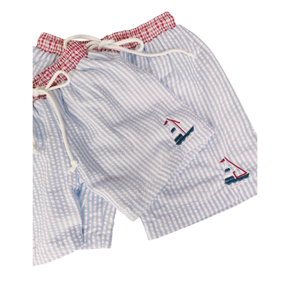 Blue checkered shorts with sailboat designs on a white background