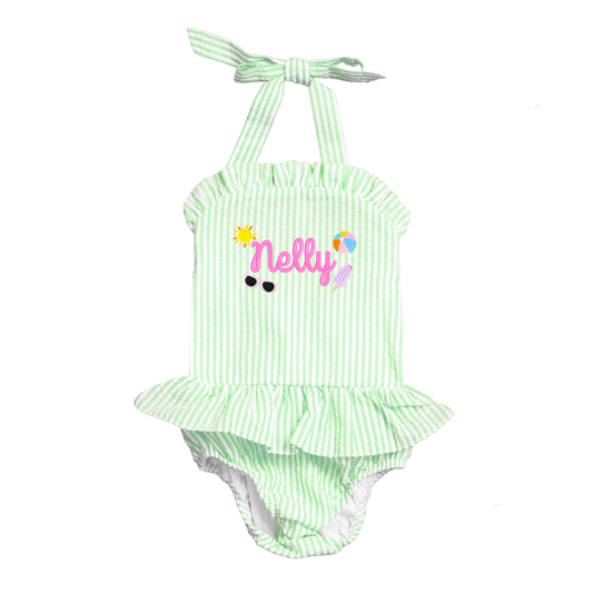 Green and white striped baby romper with 'Nelly' print on a white background