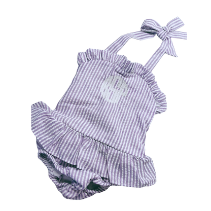 Purple and white striped baby romper with ruffled details on a white background
