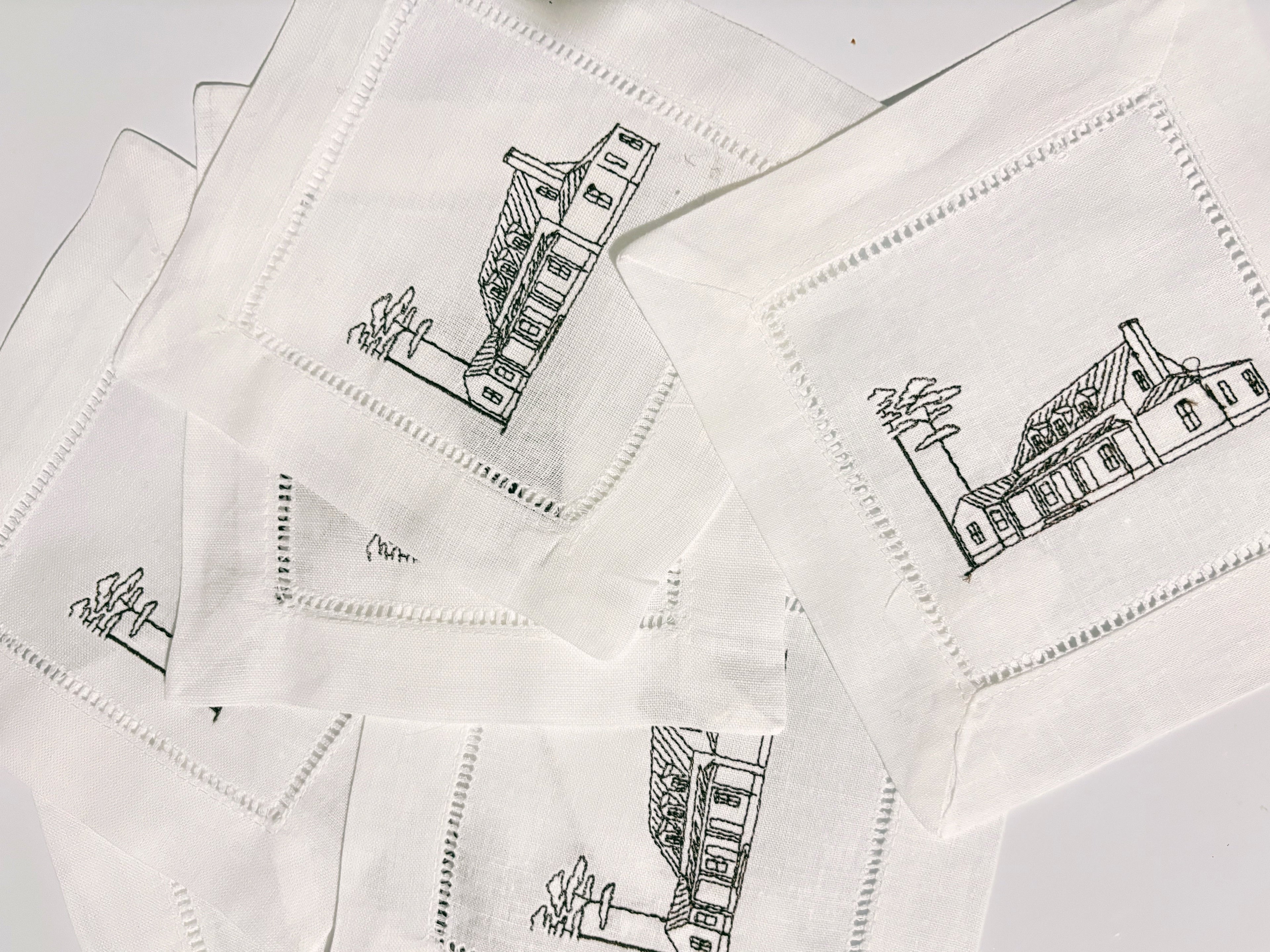 Set of white napkins with black house illustrations on a white background