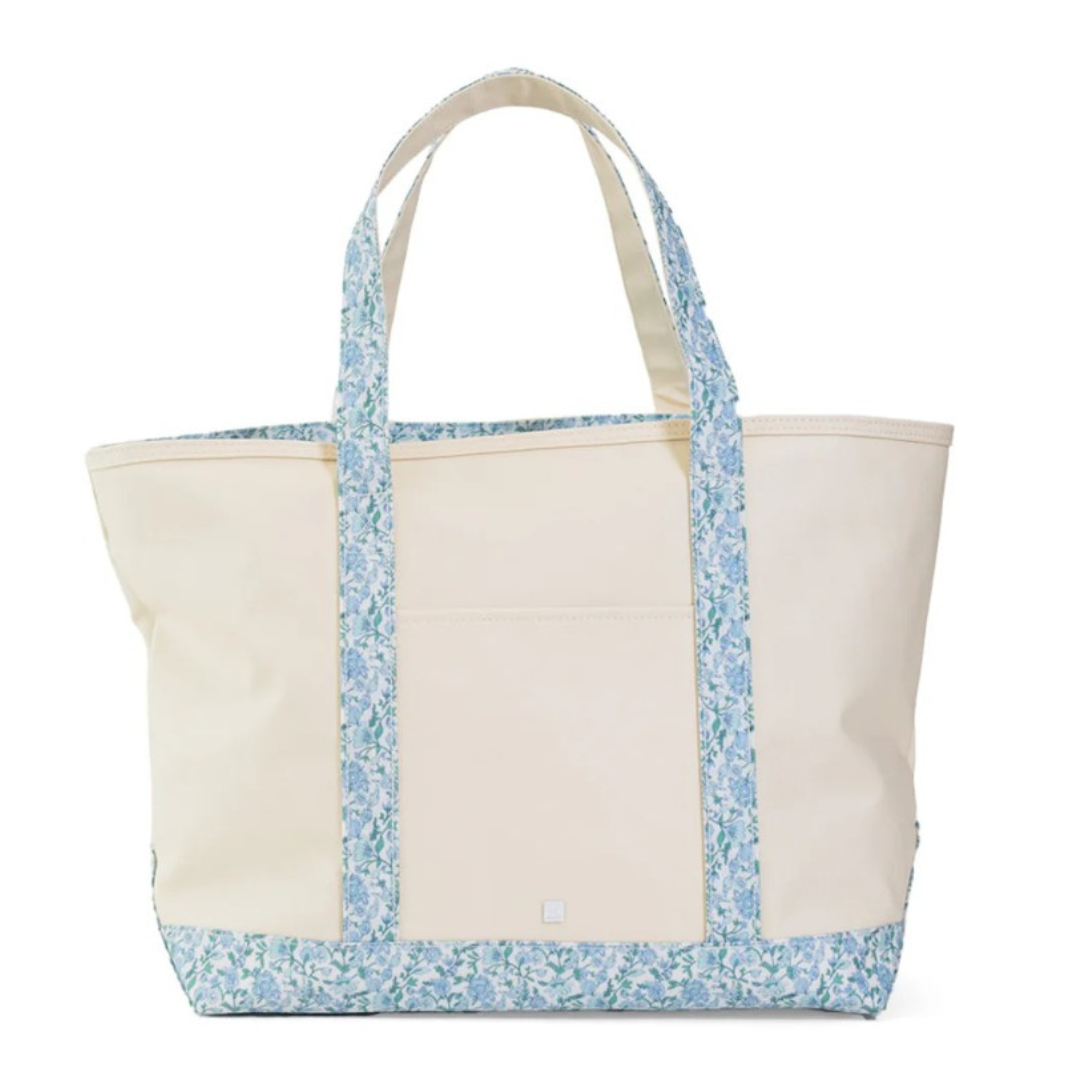 Beige tote bag with blue floral pattern on a white background