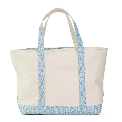 Beige tote bag with blue floral pattern on a white background