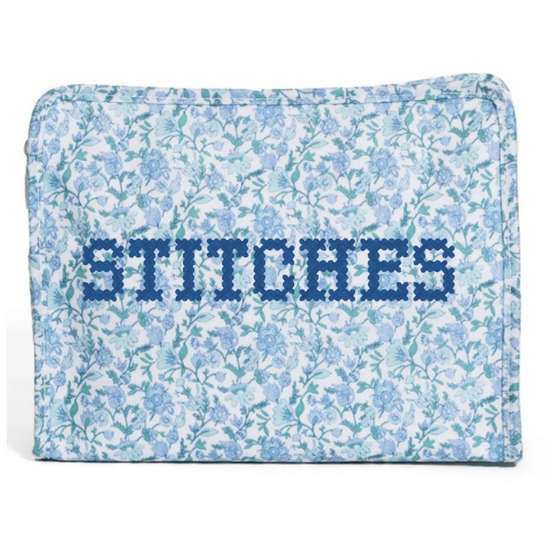 Floral-patterned pouch with 'STITCHES' text on a white background