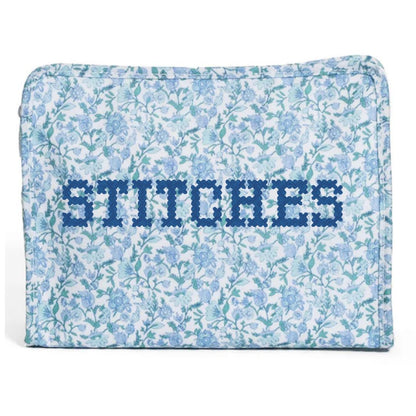 Floral-patterned pouch with 'STITCHES' text on a white background