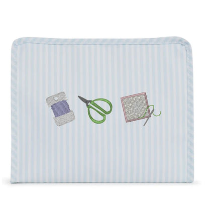 Rectangular fabric pouch with embroidered sewing tools on a light blue background